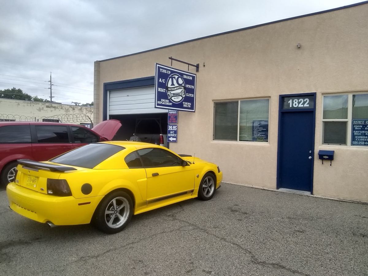 TC Automotive Repair shop front at 1822 E Mojave St, Farmington, with the TC service sign and a yellow Mustang parked out front